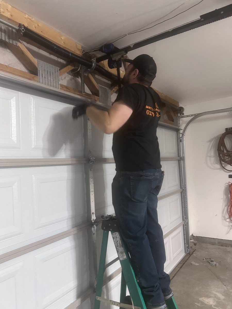 Bart setting the torsion springs on a new raised panel garage door