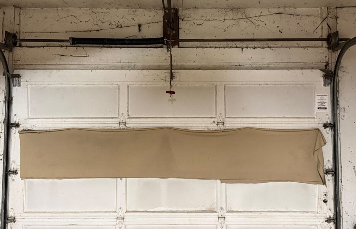 New torsion spring installed above the garage door