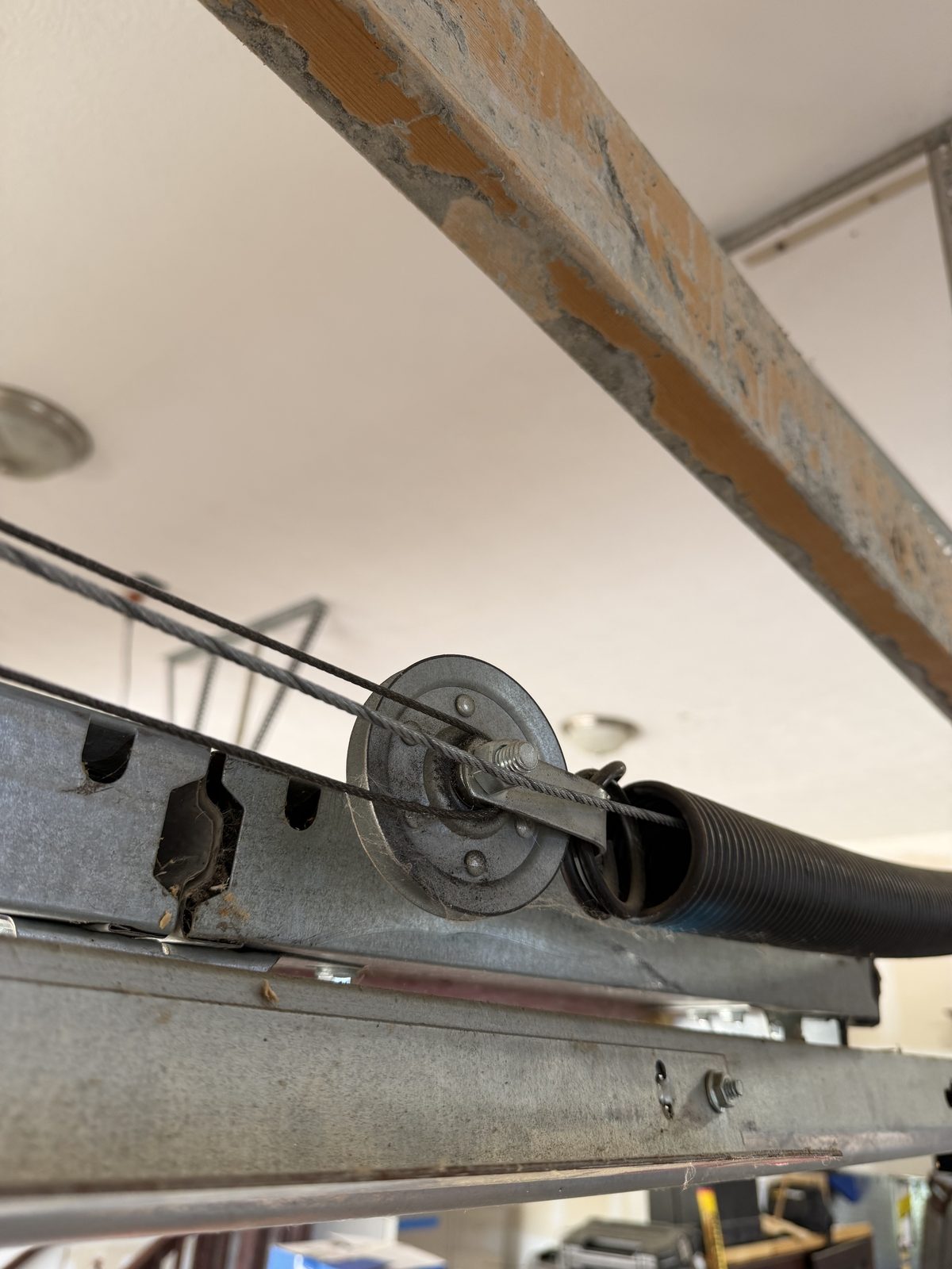 Garage door lift cable that has jumped out of the idler pulley, found during a tune-up