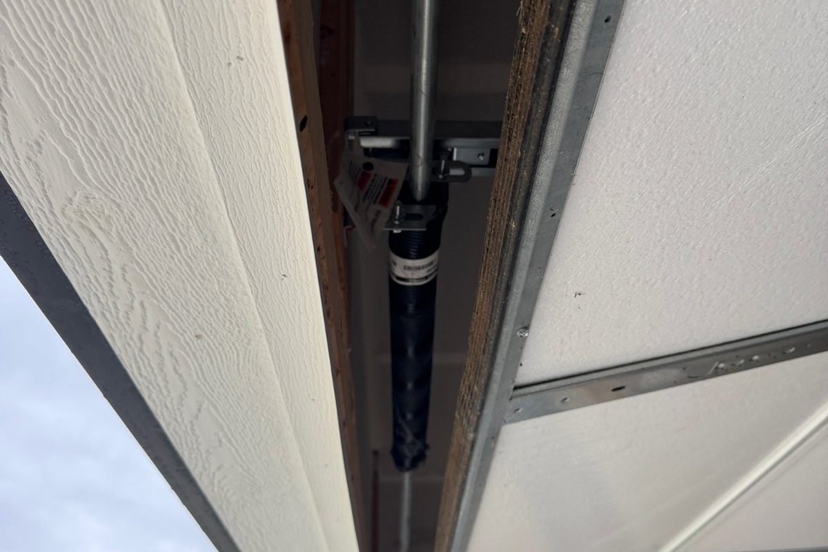 Torsion spring and bearing plate checked during a garage door tune up in Plainfield