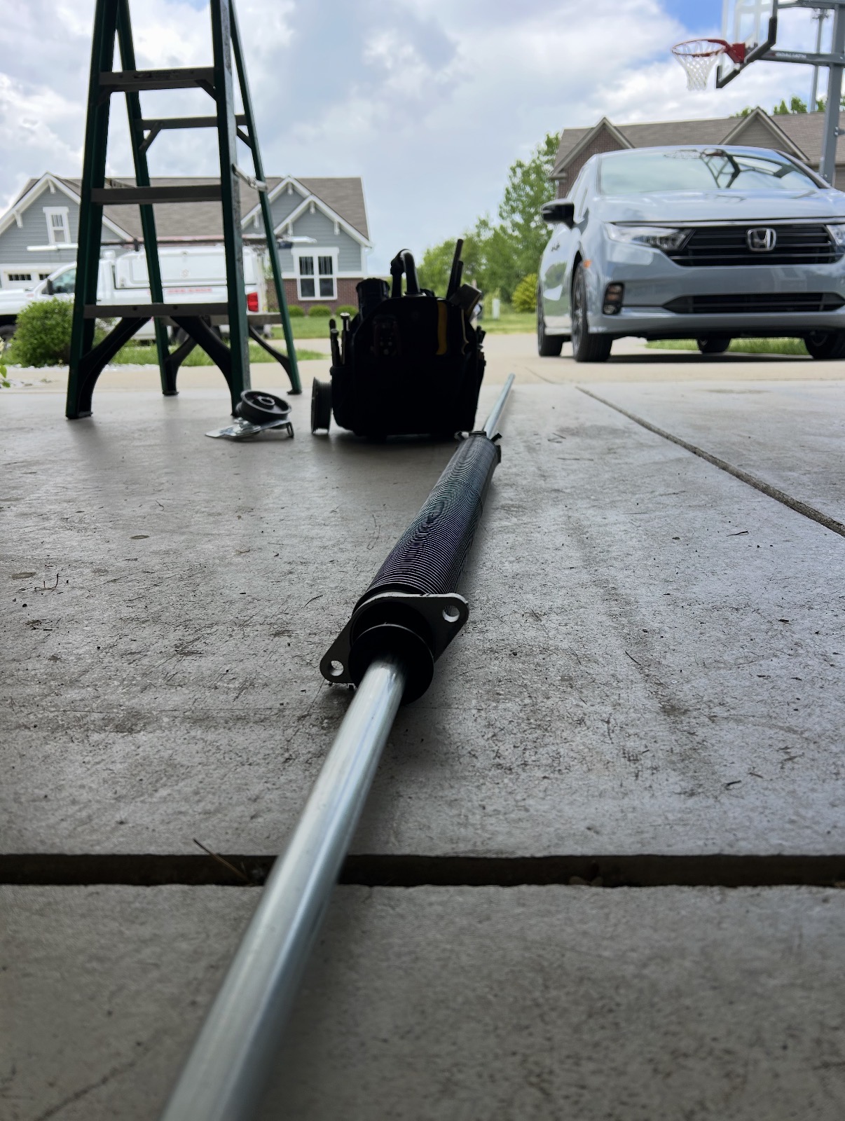 Torsion spring shaft being assembled on the driveway for a spring conversion