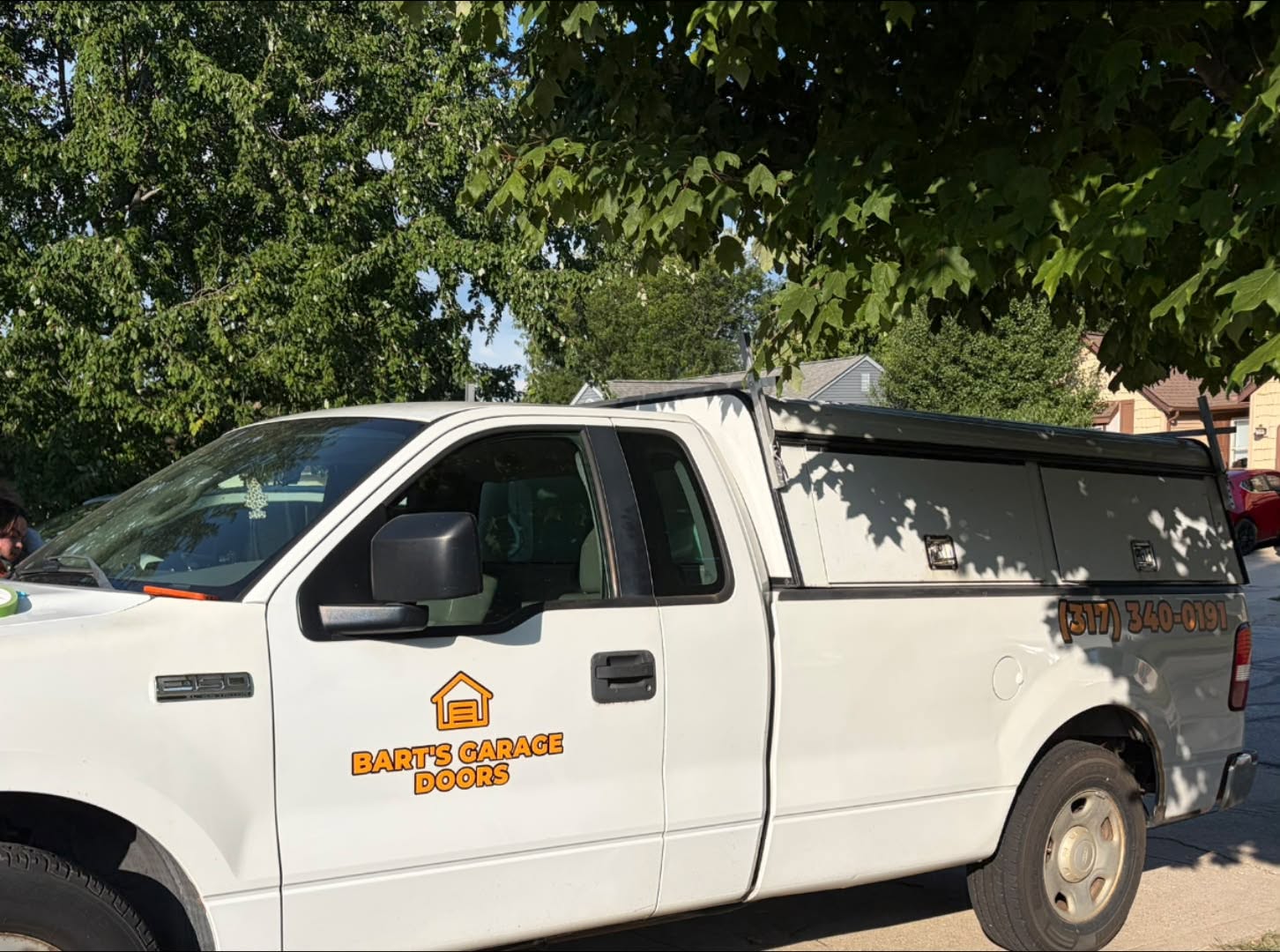 Close-up of the Bart's Garage Doors logo decal on the truck door
