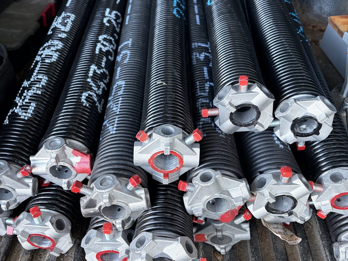Torsion springs with winding cones on the truck, ready to install